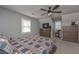 Cozy bedroom featuring a plaid bedspread, ceiling fan, and natural light at 9001 E Carroll Rd, Winston, GA 30187