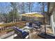 Outdoor deck area with chairs, a table, and a view of the wooded surroundings at 9001 E Carroll Rd, Winston, GA 30187