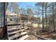Elevated wooden deck offers a charming view of the backyard's greenery and partial golf course view at 9001 E Carroll Rd, Winston, GA 30187
