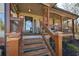 Inviting covered front porch with wooden railing and pillars, creating a cozy outdoor living space at 9001 E Carroll Rd, Winston, GA 30187