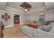 Open-concept living room with wood-look tile flooring, gray walls, and large sectional sofa at 9001 E Carroll Rd, Winston, GA 30187