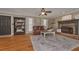 Open-concept living room with hardwood floors, a stone fireplace, and comfortable seating, ideal for relaxation at 9001 E Carroll Rd, Winston, GA 30187