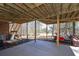 Patio featuring stairs, golf cart, wooded area, and exposed ceiling beams at 9001 E Carroll Rd, Winston, GA 30187