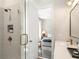 Stylish bathroom featuring a glass shower, a vanity with modern fixtures, and a view into the bedroom at 921 Hughley Circle Se # 66, Atlanta, GA 30316