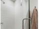 Modern shower with white subway tile, glass enclosure, and sleek fixtures with attached brown towel at 921 Hughley Circle Se # 66, Atlanta, GA 30316