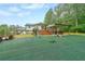 Expansive backyard with artificial turf, a spacious deck, and plenty of room for outdoor activities and play at 110 W Putnam Ferry Rd, Woodstock, GA 30189