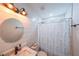 Bright bathroom features round mirror, modern lighting, and stylish fixtures at 110 W Putnam Ferry Rd, Woodstock, GA 30189