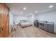 Bright bedroom featuring hardwood floors, barn doors, and a kitchenette at 110 W Putnam Ferry Rd, Woodstock, GA 30189