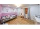 Charming Bedroom with whimsical wallpaper, hardwood floors and ample natural light at 110 W Putnam Ferry Rd, Woodstock, GA 30189