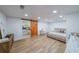 Open bedroom featuring hardwood floors, barn doors, and a kitchenette at 110 W Putnam Ferry Rd, Woodstock, GA 30189