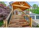 Close-up of the wooden deck with steps leading to the front door of the house at 110 W Putnam Ferry Rd, Woodstock, GA 30189