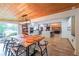 Bright open dining room, featuring hardwood ceilings, a wooden table and views of the kitchen and living area at 110 W Putnam Ferry Rd, Woodstock, GA 30189