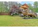 Exterior view of a well-maintained home with a spacious yard and inviting wooden deck at 110 W Putnam Ferry Rd, Woodstock, GA 30189