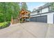 Home exterior with a large driveway leading to an attached garage and a beautiful elevated deck at 110 W Putnam Ferry Rd, Woodstock, GA 30189