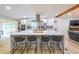 Modern kitchen with stainless appliances, white cabinetry, a large island with quartz countertops and bar stool seating at 110 W Putnam Ferry Rd, Woodstock, GA 30189