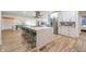 Modern kitchen with a quartz island, stainless steel appliances, and sleek countertops at 110 W Putnam Ferry Rd, Woodstock, GA 30189