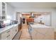 Modern kitchen featuring white cabinetry, stainless steel appliances, a farmhouse sink and a large quartz countertop center island at 110 W Putnam Ferry Rd, Woodstock, GA 30189