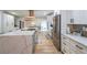 Beautiful kitchen featuring custom cabinets, stainless steel appliances, quartz countertops, and a large center island with bar seating at 110 W Putnam Ferry Rd, Woodstock, GA 30189