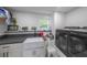 Clean, organized laundry room with modern appliances and ample counter space at 110 W Putnam Ferry Rd, Woodstock, GA 30189