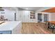 Open living space featuring custom cabinets, wood look floors, and a view of the dining room at 110 W Putnam Ferry Rd, Woodstock, GA 30189