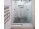 Luxurious marble shower with dual showerheads and river rock floor at 110 W Putnam Ferry Rd, Woodstock, GA 30189