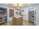 Well-organized walk-in closet with custom shelving, ample storage space, and a stylish light fixture at 110 W Putnam Ferry Rd, Woodstock, GA 30189