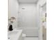 Bright bathroom featuring white tiling around a bathtub with a shower and a white basin at 1161 Dahlonega Hwy # 9, Cumming, GA 30040