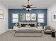 Comfortable bedroom highlighted by a stylish navy blue wall and coordinated window treatments at 1161 Dahlonega Hwy # 9, Cumming, GA 30040