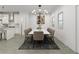 Open dining area features modern chandelier and seating for ten guests at 1161 Dahlonega Hwy # 9, Cumming, GA 30040