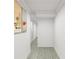 Hallway with white walls, light wood floors, crown molding and painting at 1161 Dahlonega Hwy # 9, Cumming, GA 30040