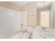 Bright bathroom with a bathtub, white tile surround, and a white vanity at 3505 Belridge Ln, Smyrna, GA 30080