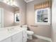 Bathroom with a large mirror, white vanity and a window at 3505 Belridge Ln, Smyrna, GA 30080