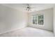 Empty bedroom with a ceiling fan, carpet flooring and a large window providing ample natural light at 3505 Belridge Ln, Smyrna, GA 30080