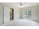 Bedroom showcasing a window, open door to bathroom, ceiling fan, and carpeted flooring at 3505 Belridge Ln, Smyrna, GA 30080