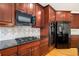 Modern kitchen with granite countertops, stainless steel appliances, and custom cabinetry provides elegance at 3505 Belridge Ln, Smyrna, GA 30080
