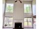 Bright living room features a fireplace with grand windows offering an abundance of natural light at 3505 Belridge Ln, Smyrna, GA 30080