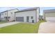 Backyard with a gray two-car garage, and a small grassy area at 3658 Madison St, College Park, GA 30337