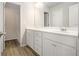 Large bathroom with a double vanity, a mirror, and wood look flooring at 3658 Madison St, College Park, GA 30337