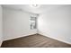 A simple bedroom features neutral paint and a bright window at 3658 Madison St, College Park, GA 30337