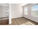 Carpeted bedroom with open doorway and two windows with mini-blinds at 3658 Madison St, College Park, GA 30337