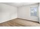 A carpeted bedroom features bright, neutral paint, and a window with blinds at 3658 Madison St, College Park, GA 30337
