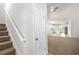 Inviting entryway featuring a staircase, coat closet, and open view into the kitchen at 3658 Madison St, College Park, GA 30337