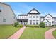 Charming two-story home featuring a well-manicured lawn and inviting brick pathway at 3658 Madison St, College Park, GA 30337