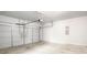 A two car garage with light grey walls, an automatic door, and a concrete floor at 3658 Madison St, College Park, GA 30337