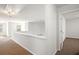 Bright hallway area with neutral paint, carpet, and an opening to another room at 3658 Madison St, College Park, GA 30337