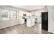Bright kitchen with stainless appliances, island, white cabinets, and updated finishes at 3658 Madison St, College Park, GA 30337