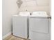 A laundry room with bright light holds a washer and dryer with wire rack shelving at 3658 Madison St, College Park, GA 30337