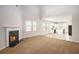 Open-concept layout with a fireplace, carpeted living area, and bright kitchen in the background at 3658 Madison St, College Park, GA 30337