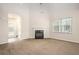 Bright living room with a fireplace, plush carpeting, and lots of natural light at 3658 Madison St, College Park, GA 30337