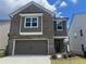 Charming two-story home with a brick facade, two-car garage and welcoming front entrance at 4554 Eastbrook Pl, Snellville, GA 30039